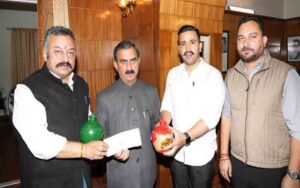 School children presented piggy bank amount for disaster relief fund.